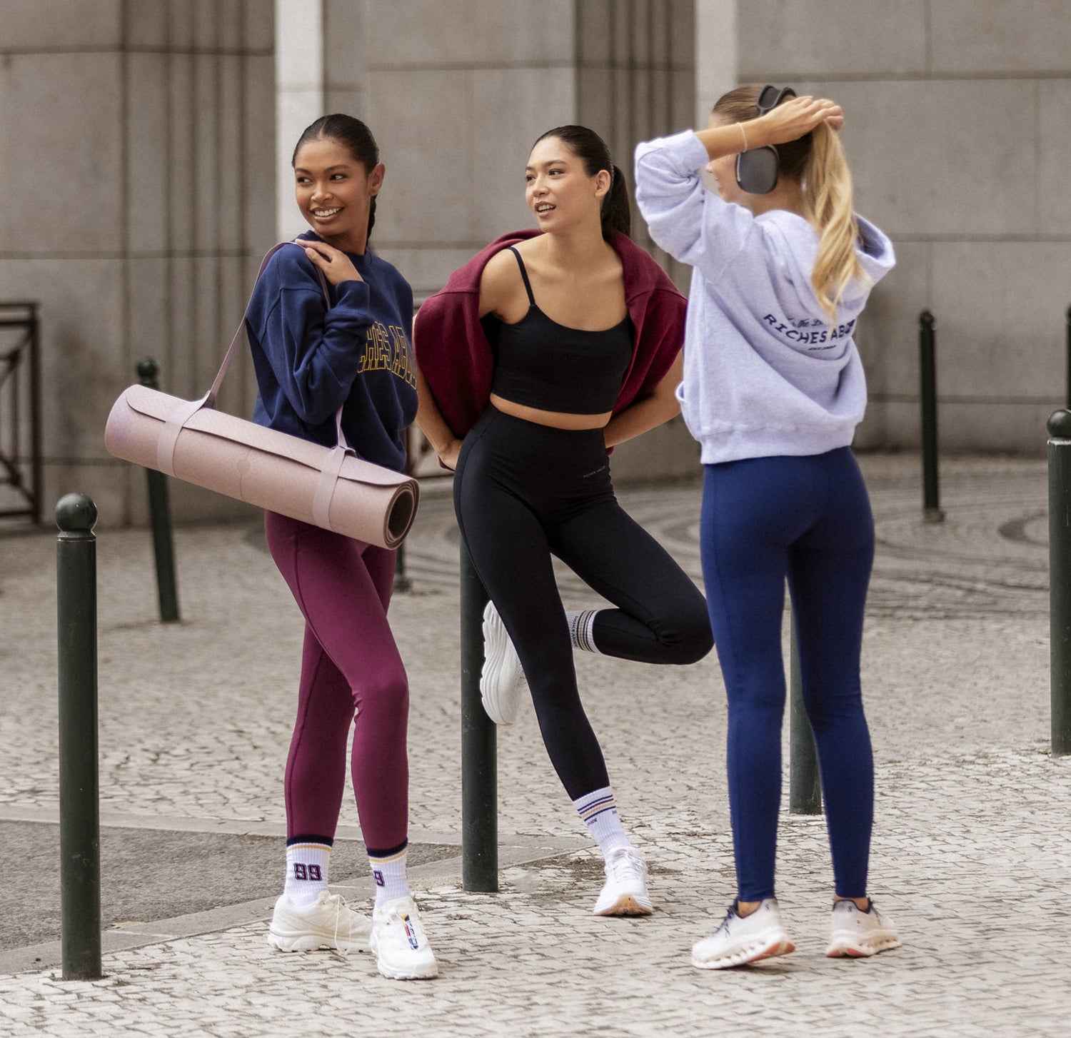 Group of friends wearing Riches Abode activewear in a lifestyle shot, showcasing the comfort and style of leggings, hoodies, and accessories.