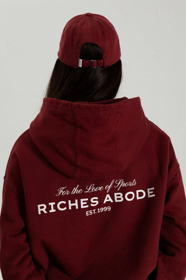 Riches Abode oversized hoodie in a deep Bordeaux shade, featuring subtle branding. Made with breathable, eco-conscious materials