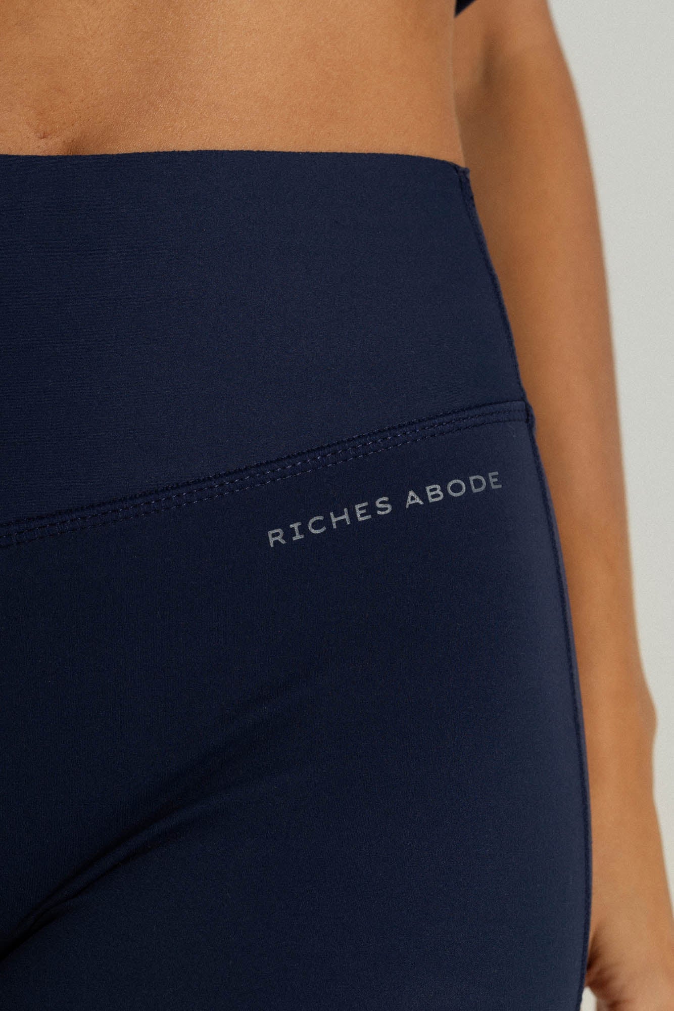 Riches Abode leggings in navy, crafted with sustainable, stretchy fabric. Offers support and comfort for movement and all-day wear