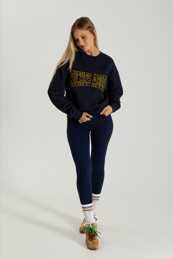 Riches Abode sweatshirt in navy blue with understated branding. Made with eco-conscious materials for timeless and versatile wear