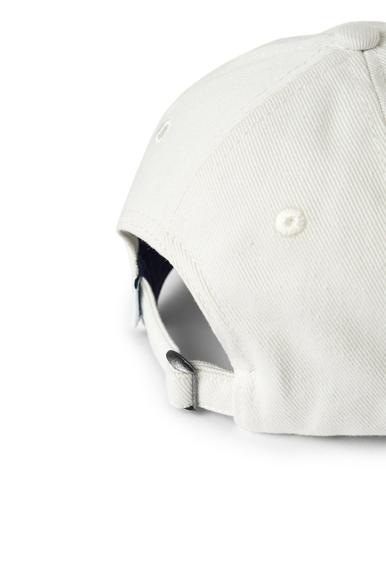 Riches Abode Serena cap in white, featuring a curved brim and adjustable strap. Made from sustainable materials for everyday wear