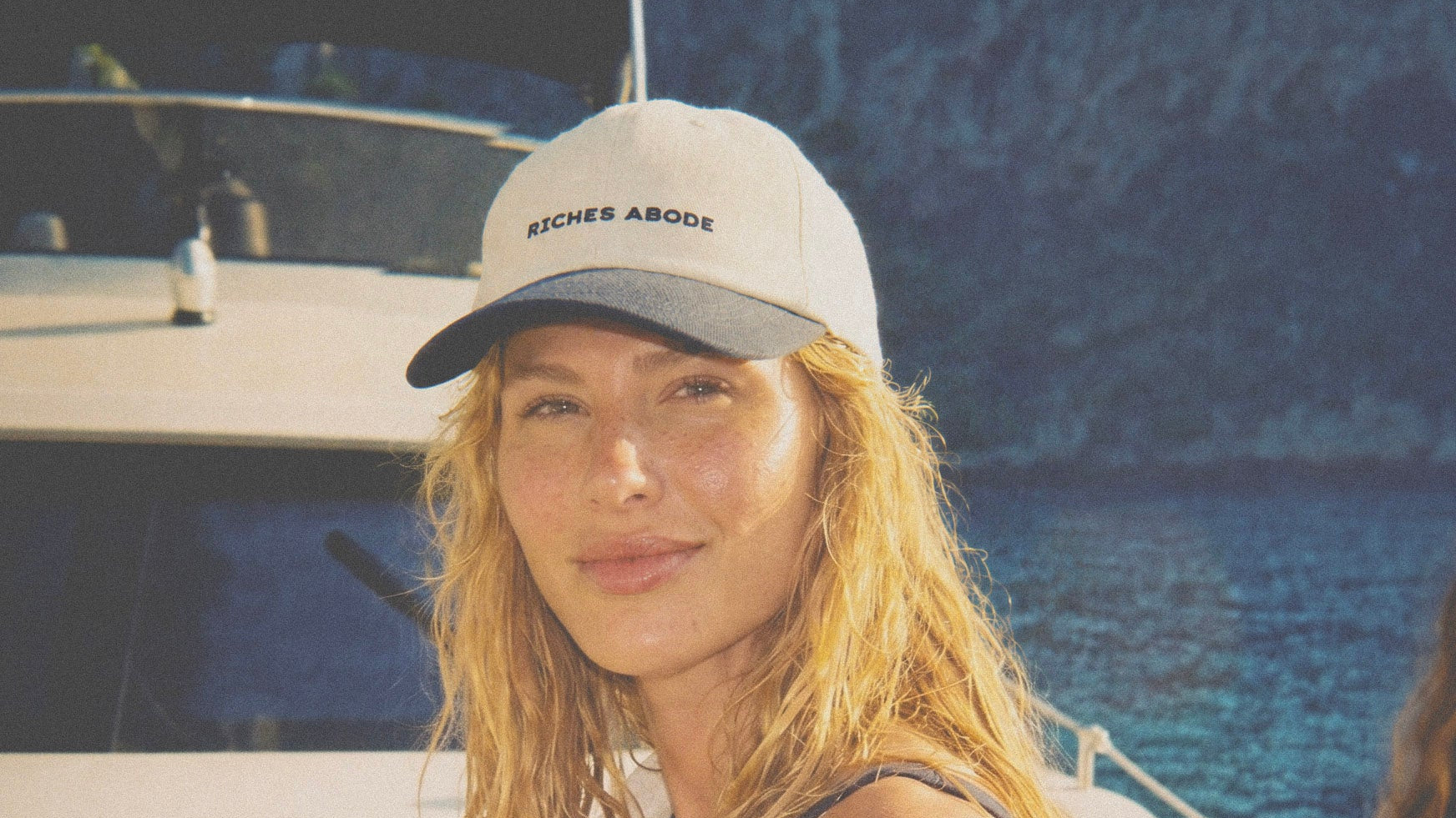 SERENA cream and navy cap, worn on a yacht