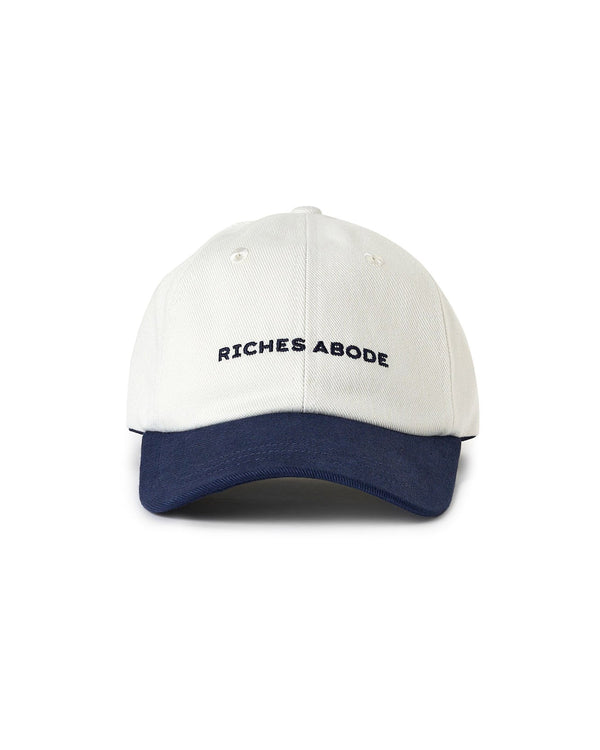 Riches Abode cap in white and navy, designed with a clean, modern look and sustainable materials. Perfect for casual outings